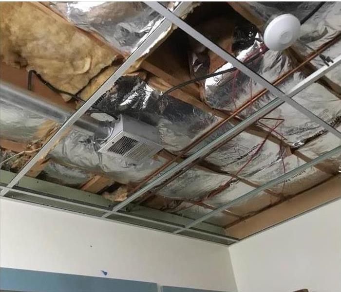 a picture of exposed duct work in ceiling